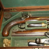 A pair of Flintlock Rifle Barrelled Travelling Pistols in original box. Very rare to find an item like this in such excellent condition. Dated 1840. Maker Trulock of Dublin. Includes research from internet regarding previous owners. When barrel is removed the name of the original owner is inscribed.